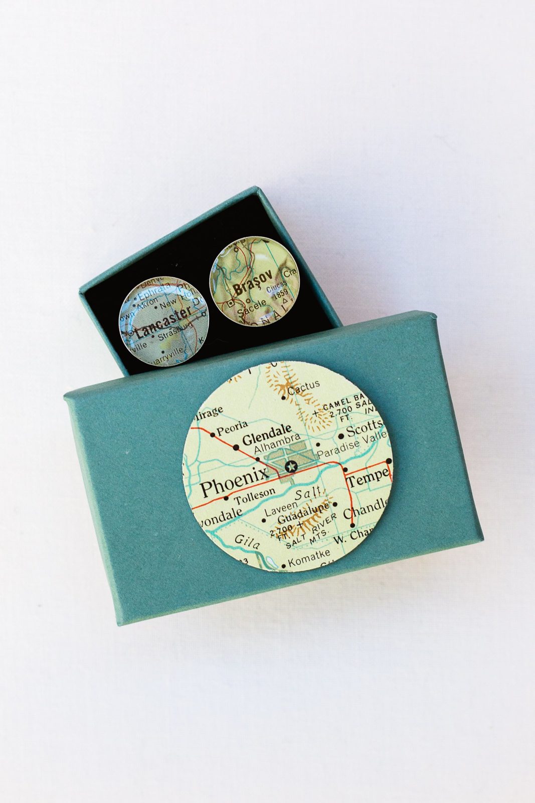 Groom's custom cufflinks with the cities he and his future wife were born by PMA Photography.