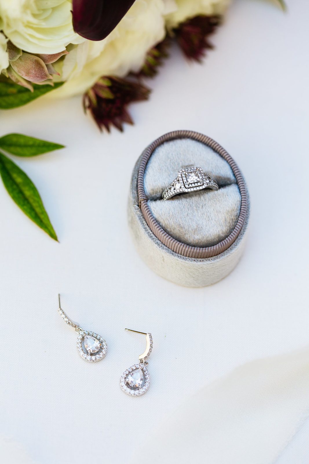 Brides white gold square wedding ring and drop earrings by PMA Photography.