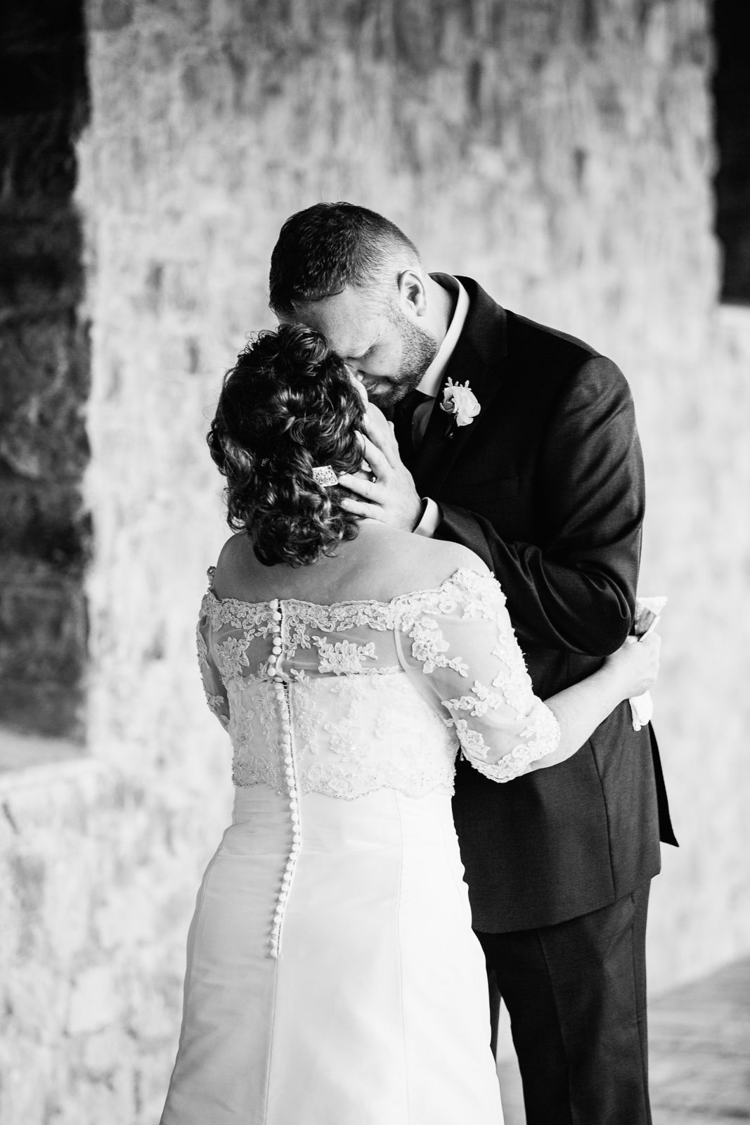 Bride and groom share an intimate moment during their first look at Superstition Mountain Clubhouse by Arizona wedding photographer PMA Photography.