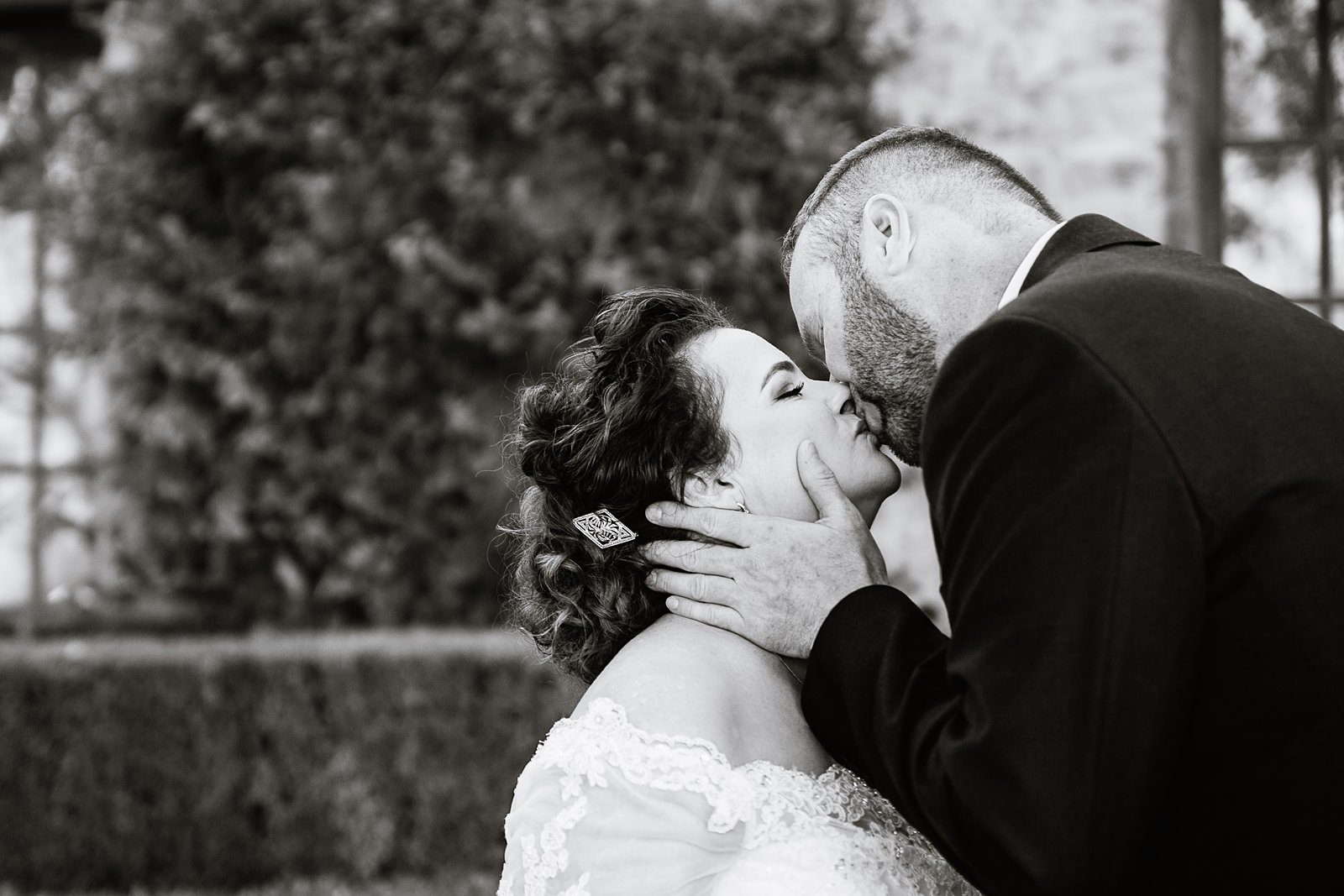 Bride and groom share a kiss during their Superstition Mountain Clubhouse wedding by Arizona wedding photographer PMA Photography.