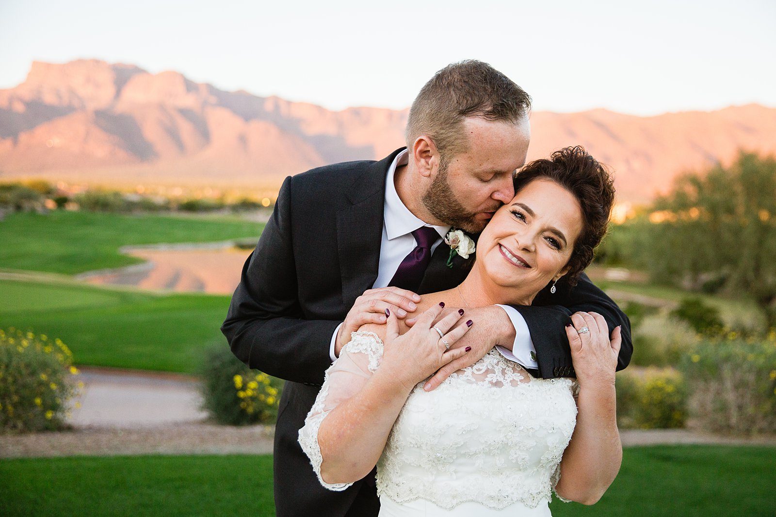 Bride and groom pose during their Superstition Mountain Clubhouse wedding by Arizona wedding photographer PMA Photography.