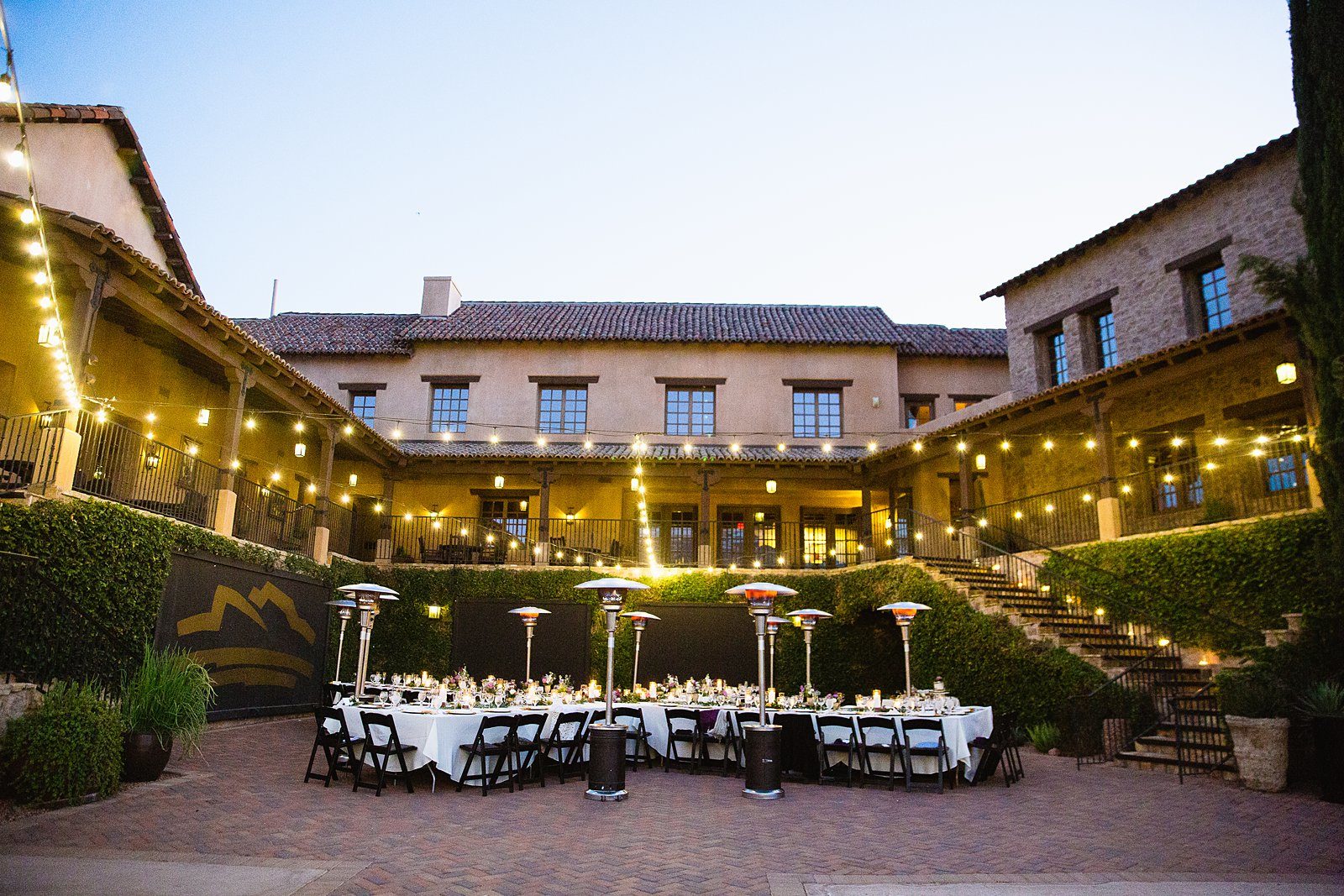 Dinner reception set up under string lights at the Superstition Mountain Clubhouse by Arizona wedding photographer PMA Photography.