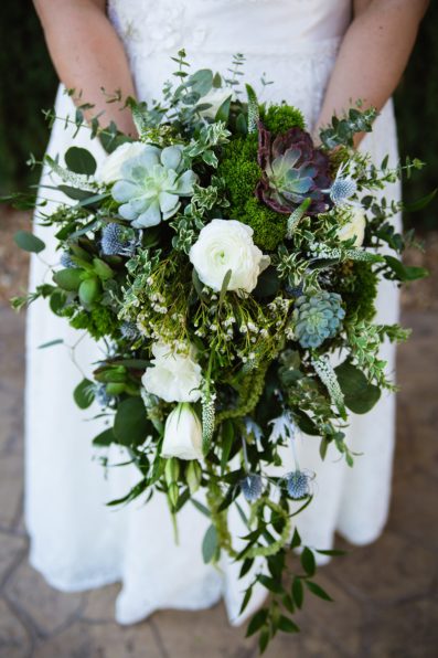 Bride's large and wild white and green garden inspired bouquet with succulents by PMA Photography.