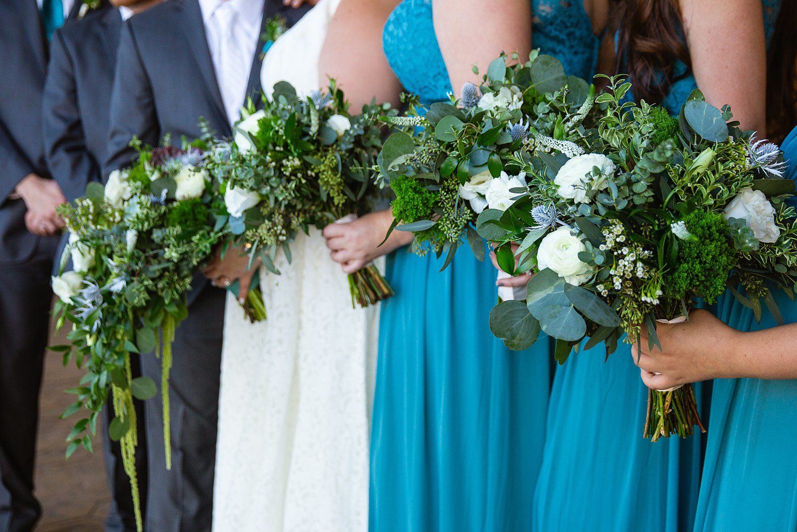Close up image of wild white and blue garden inspired bridesmaids' bouquets by PMA Photography.