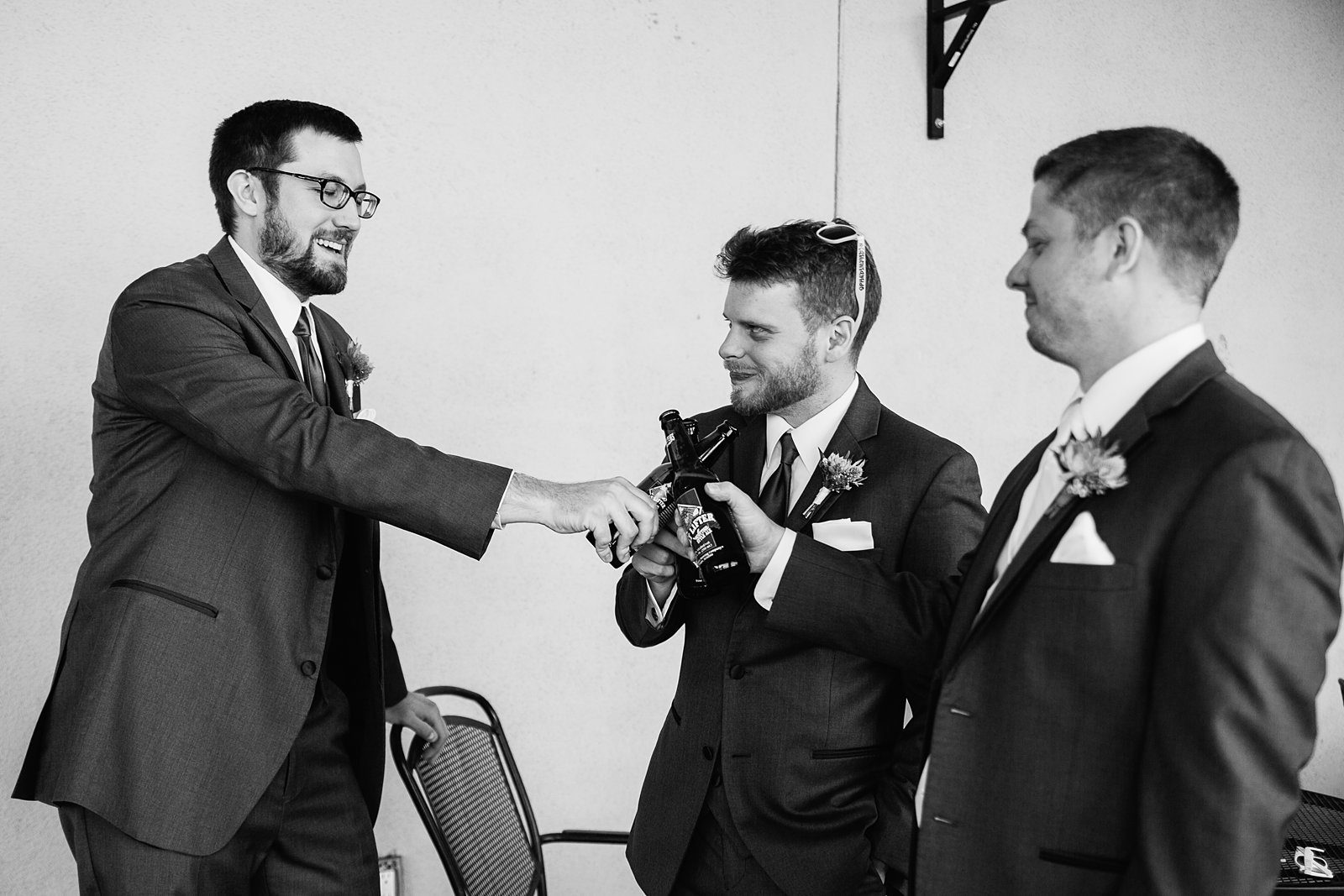 Groom and groomsmen toasting together at Superstition Manor wedding by Mesa wedding photographer PMA Photography.