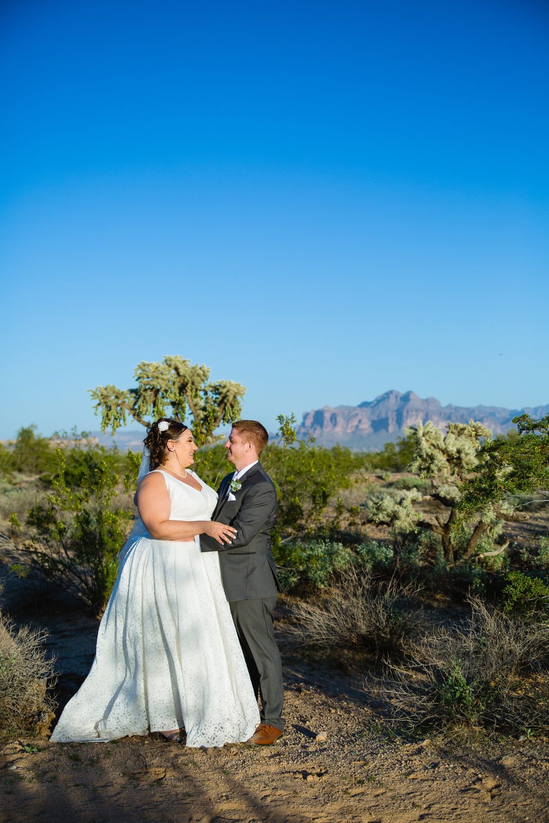 Bride and Groom pose for their Superstition Manor wedding by Mesa wedding photographer PMA Photography.