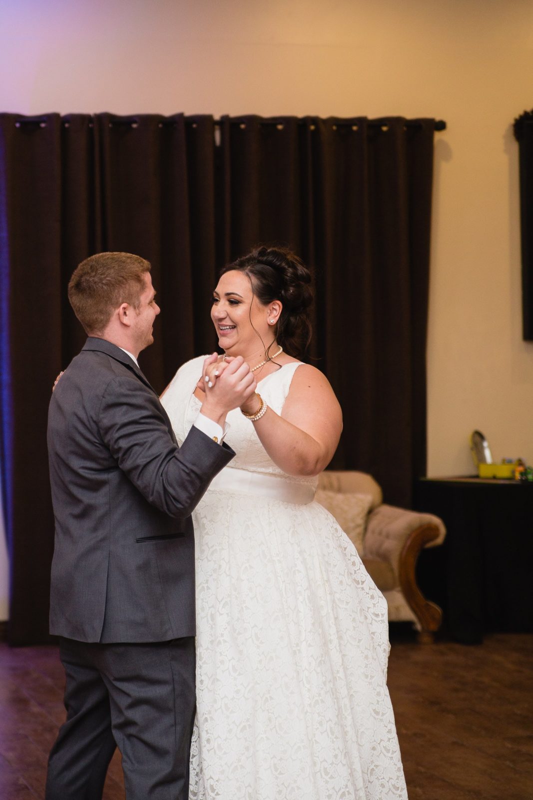 Bride and Groom sharing first dance at their Supserstition Manor wedding reception by Arizona wedding photographer PMA Photography.