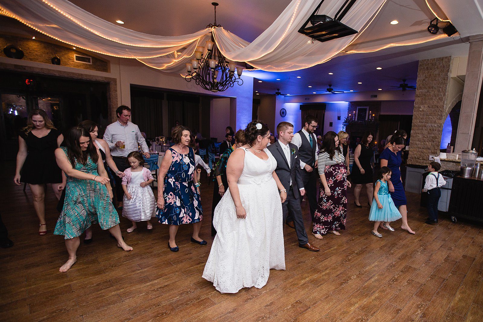 Bride and Groom dancing with guests at their Supserstition Manor wedding reception by Arizona wedding photographer PMA Photography