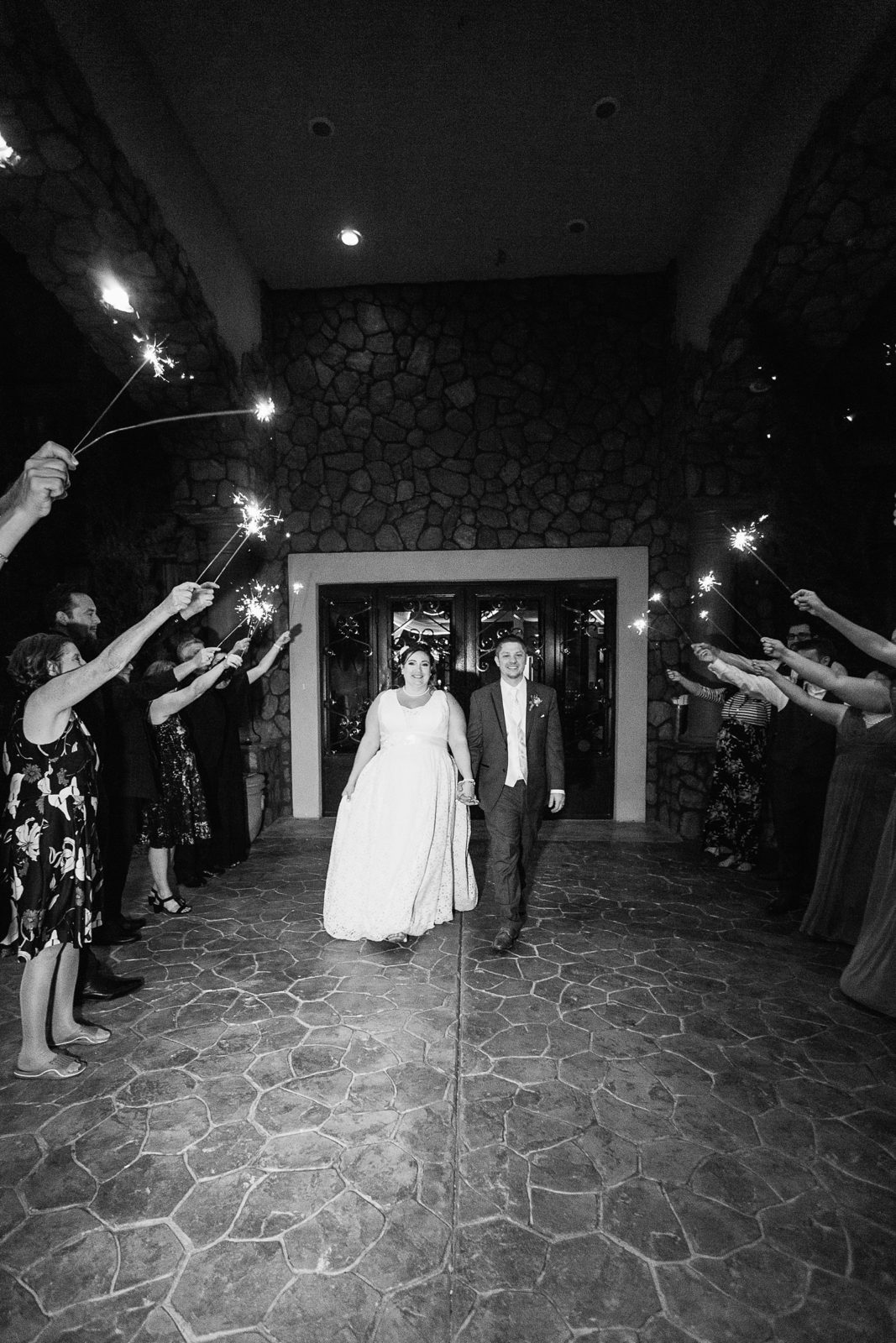 Bride and groom during their sparkler exit by PMA Photography.