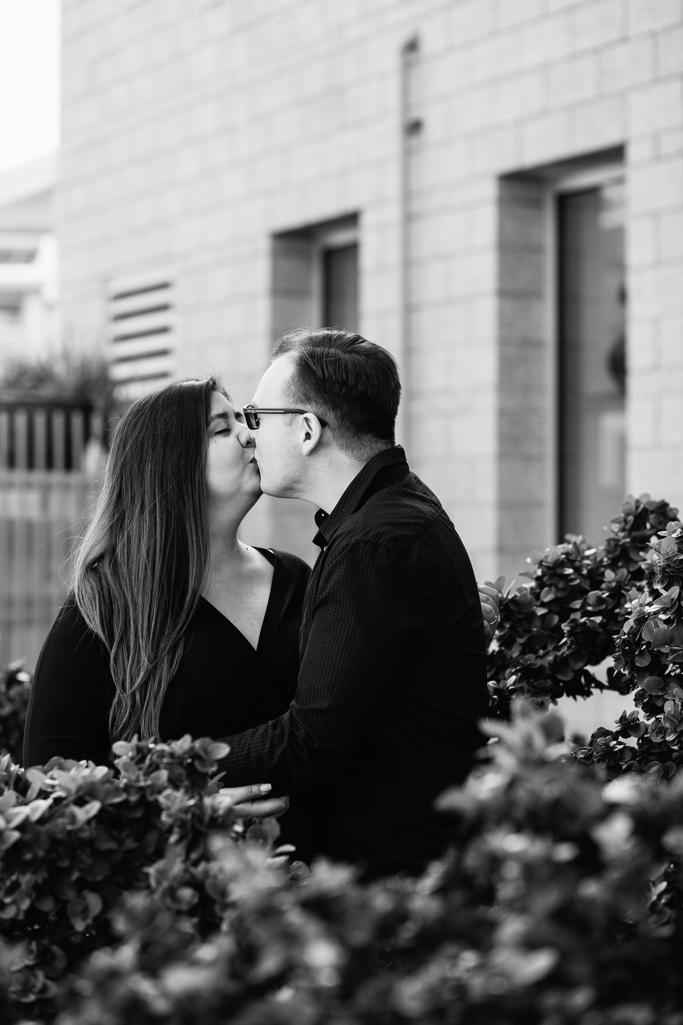 Couple share a kiss during their Mesa Arts Center engagement session by Mesa wedding photographer PMA Photography.