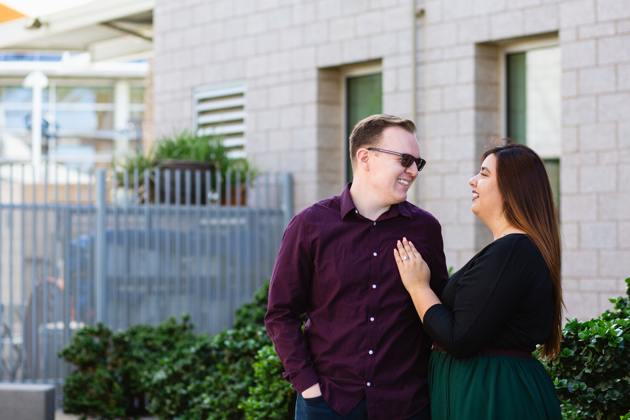 Couple laugh together during their Mesa engagement session by Arizona engagement photographer PMA Photography.