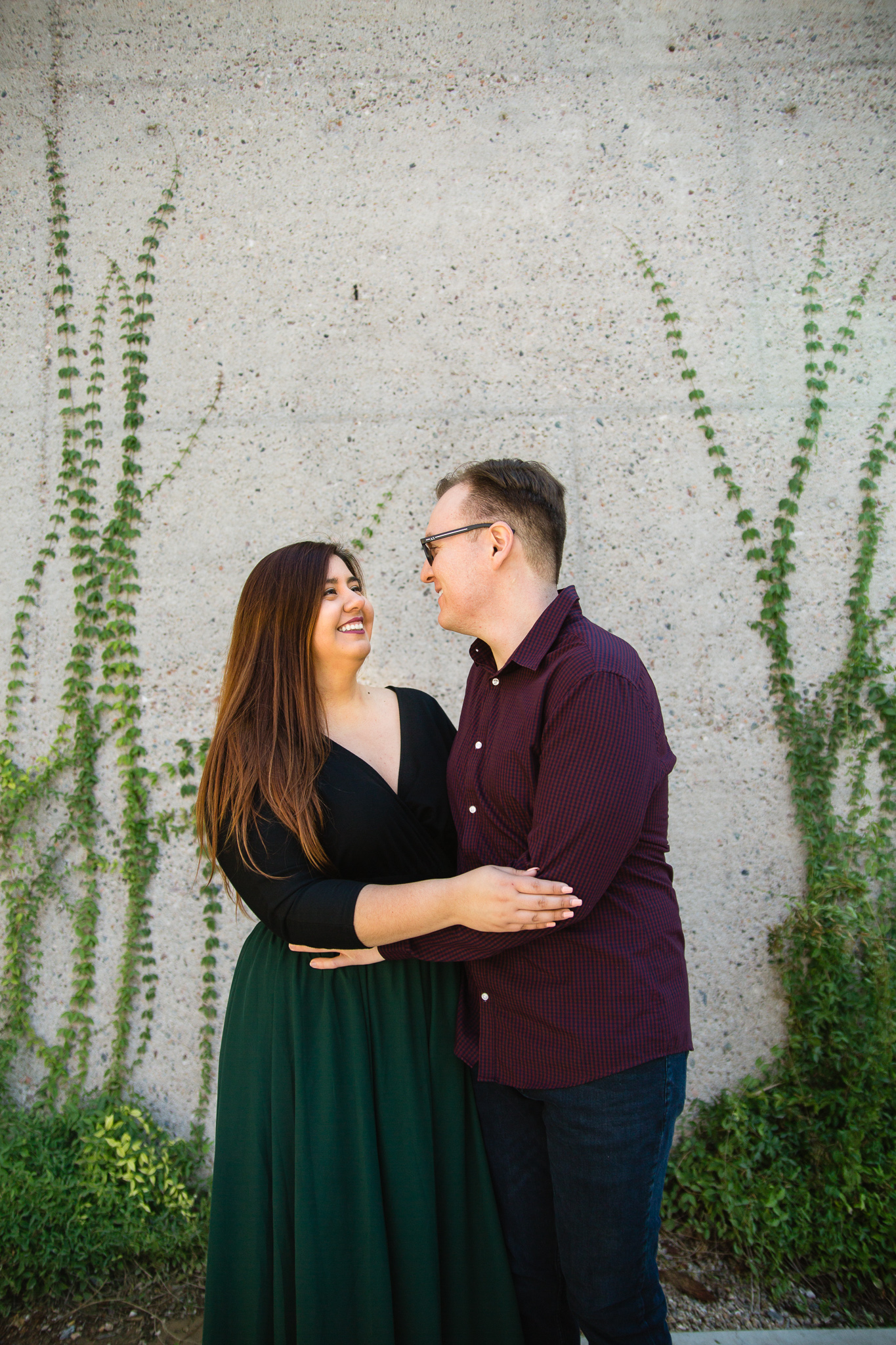 Couple laugh together during their Mesa Arts Center engagement session by Mesa engagement photographer PMA Photography.