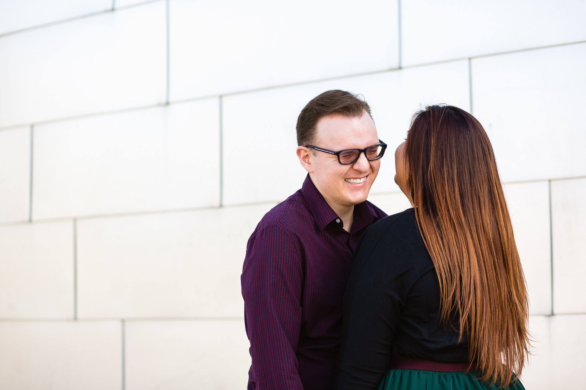 Couple laugh together during their Mesa engagement session by Arizona engagement photographer PMA Photography.