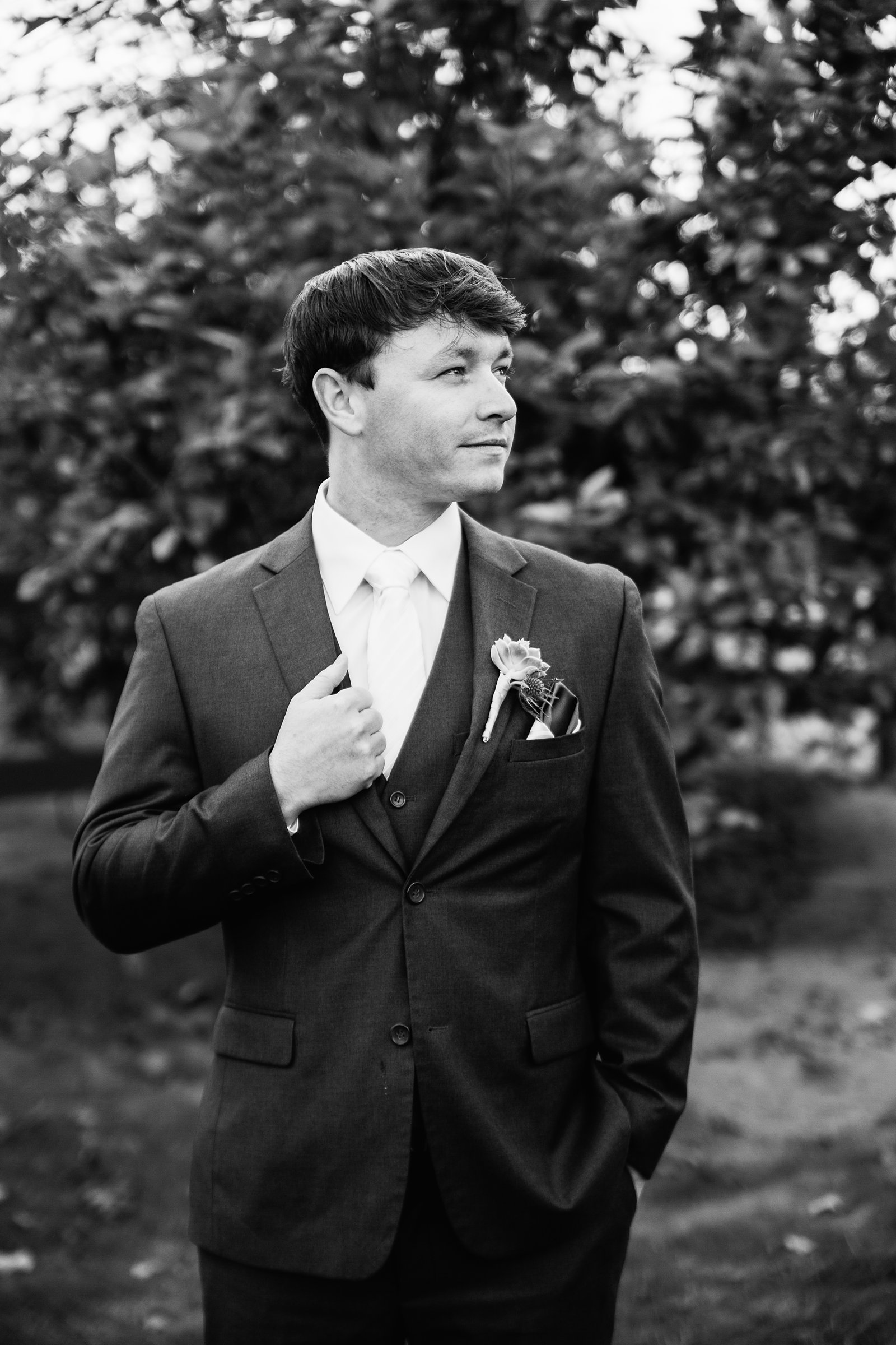Black and white image of groom on his wedding day by Phoenix wedding photographer PMA Photography.