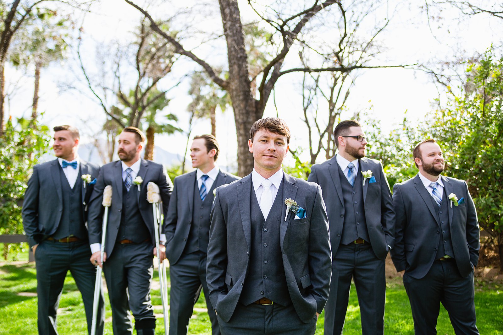 Groom and groomsmen together at a Venue At The Grove wedding by Arizona wedding photographer PMA Photography.