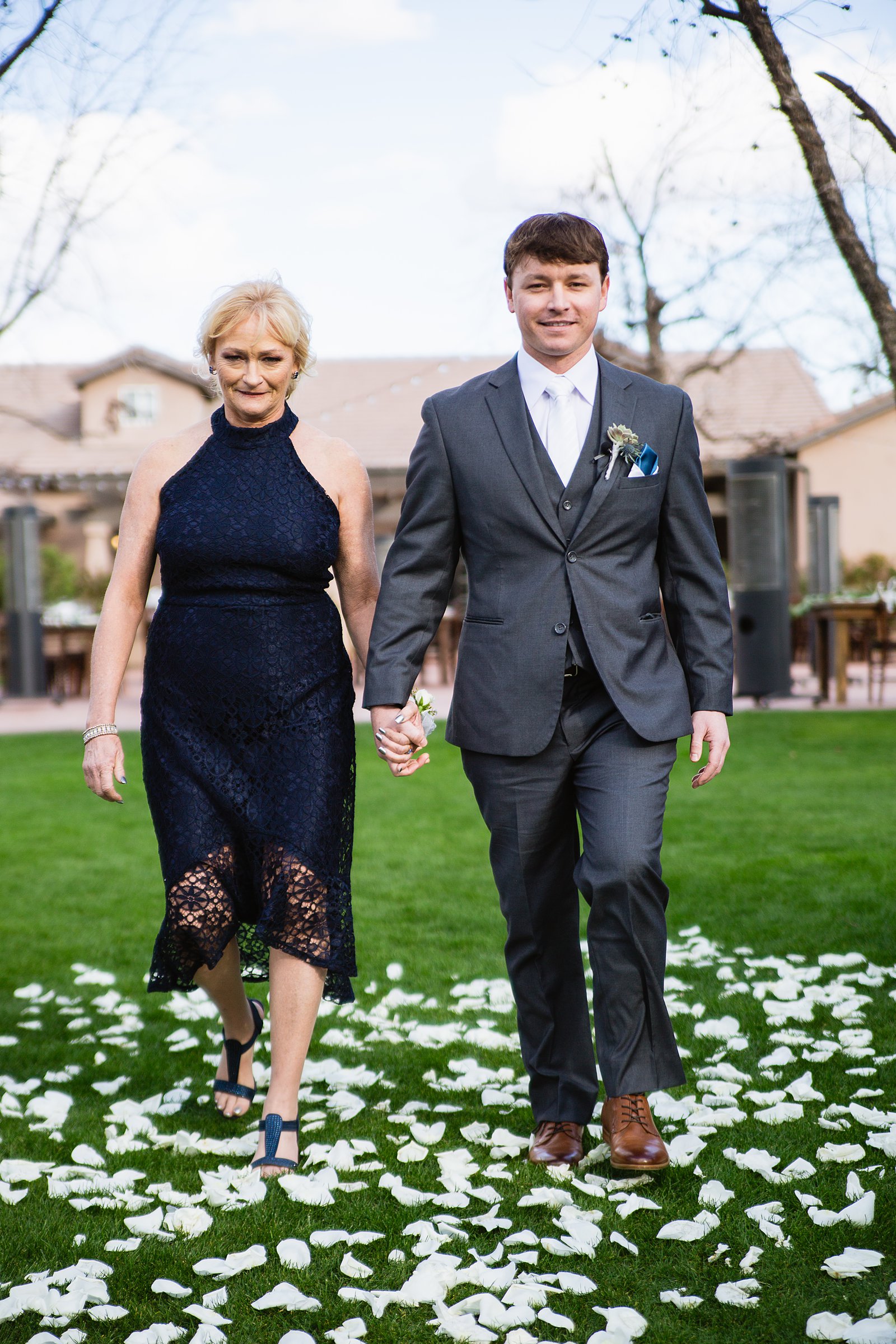 Groom walking down aisle with is mother during Venue At The Grove wedding ceremony by Arizona wedding photographer PMA Photography.