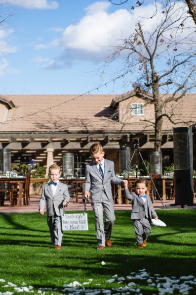 Ringbearers walking down the aisle together at a Venue at the Grove wedding by Arizona wedding photographer PMA Photography.
