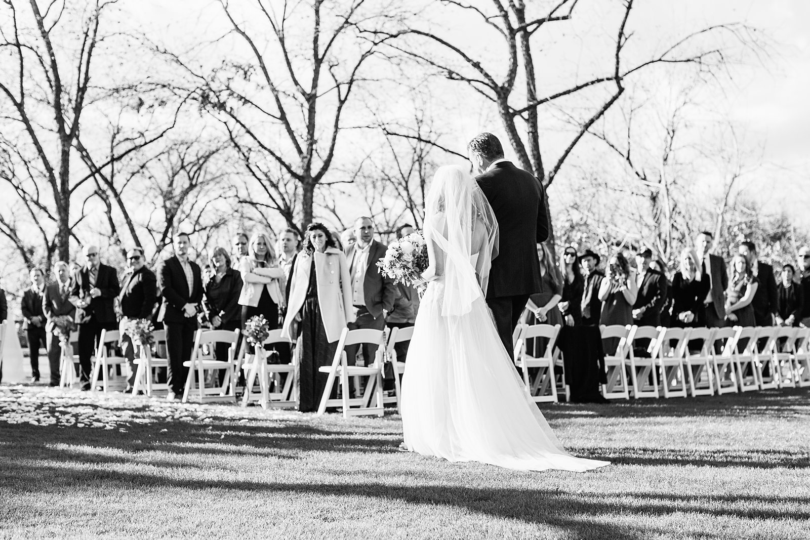 Bride walking down aisle during Venue At The Grove wedding ceremony by Arizona wedding photographer PMA Photography.