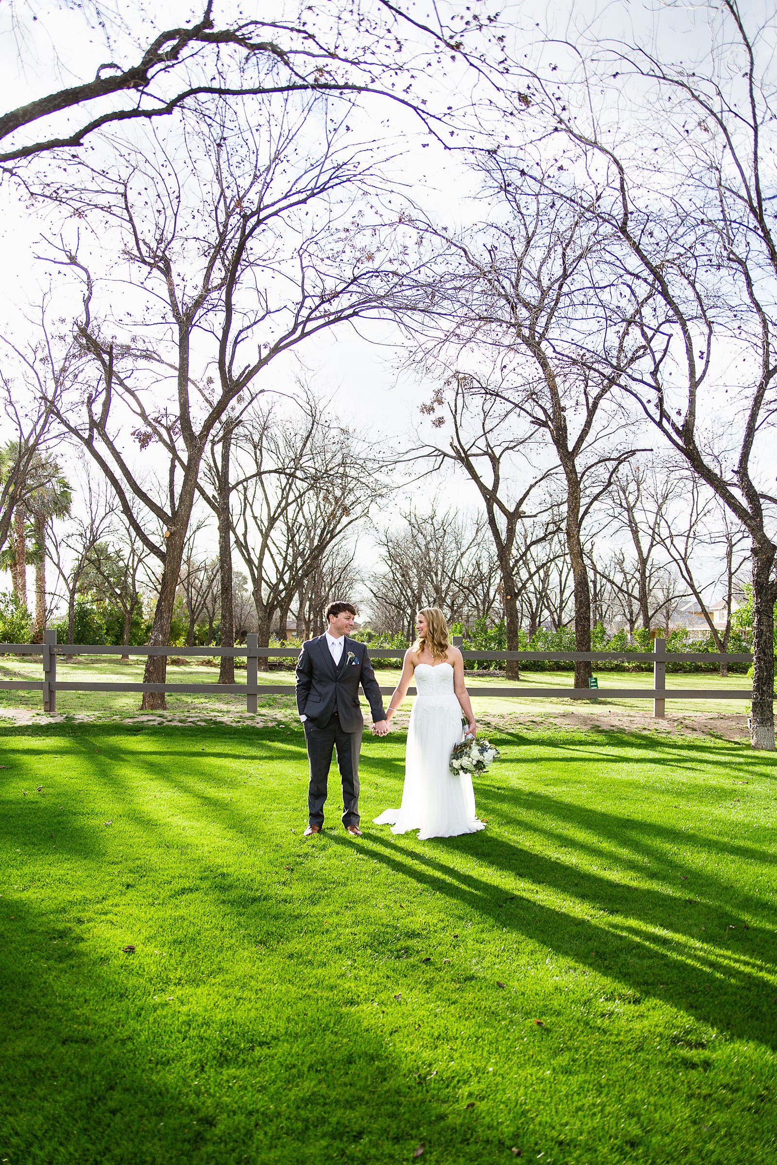 Bride and Groom pose during their Venue At The Grove wedding by Arizona wedding photographer PMA Photography.