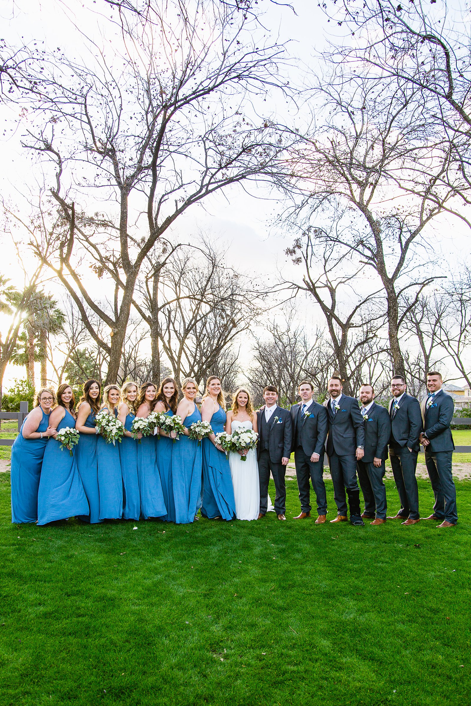 Bridal party together at a Venue At The Grove wedding by Arizona wedding photographer PMA Photography.