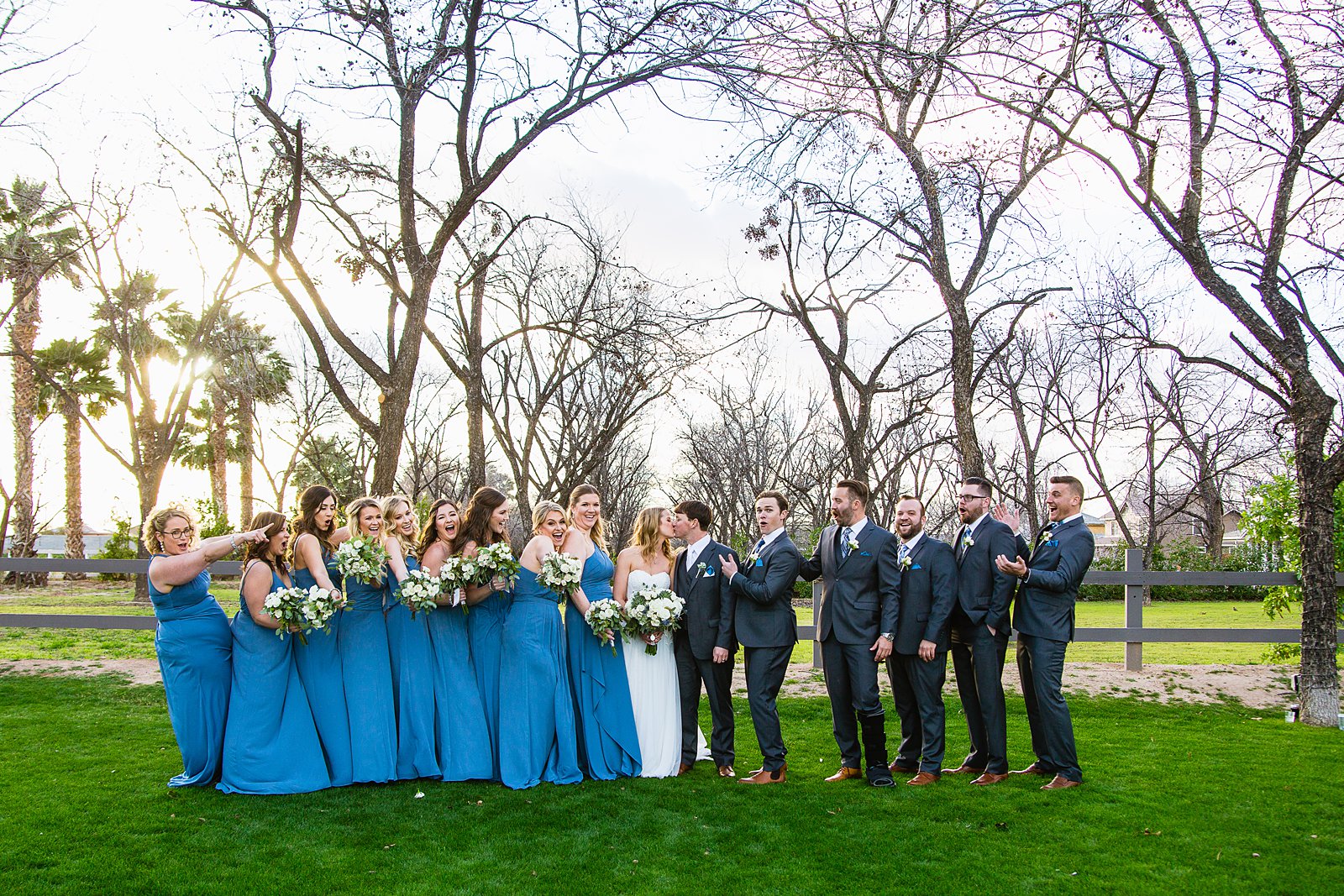 Bridal party having fun together at Venue At The Grove weding by Arizona wedding photographer PMA Photography.