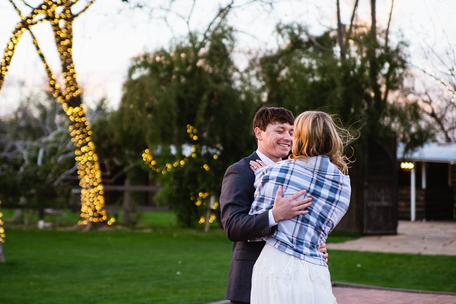 Bride and Groom sharing first dance at their Venue At The Grove wedding reception by Arizona wedding photographer PMA Photography.