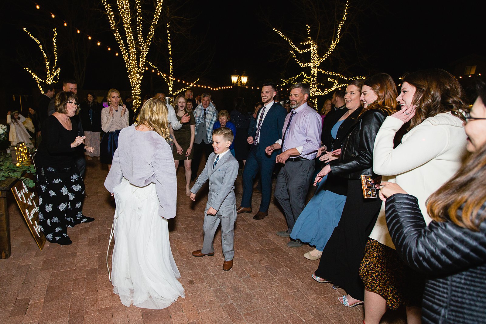 Bride dancing with guests at Venue At The Grove wedding reception by Phoenix wedding photographer PMA Photography