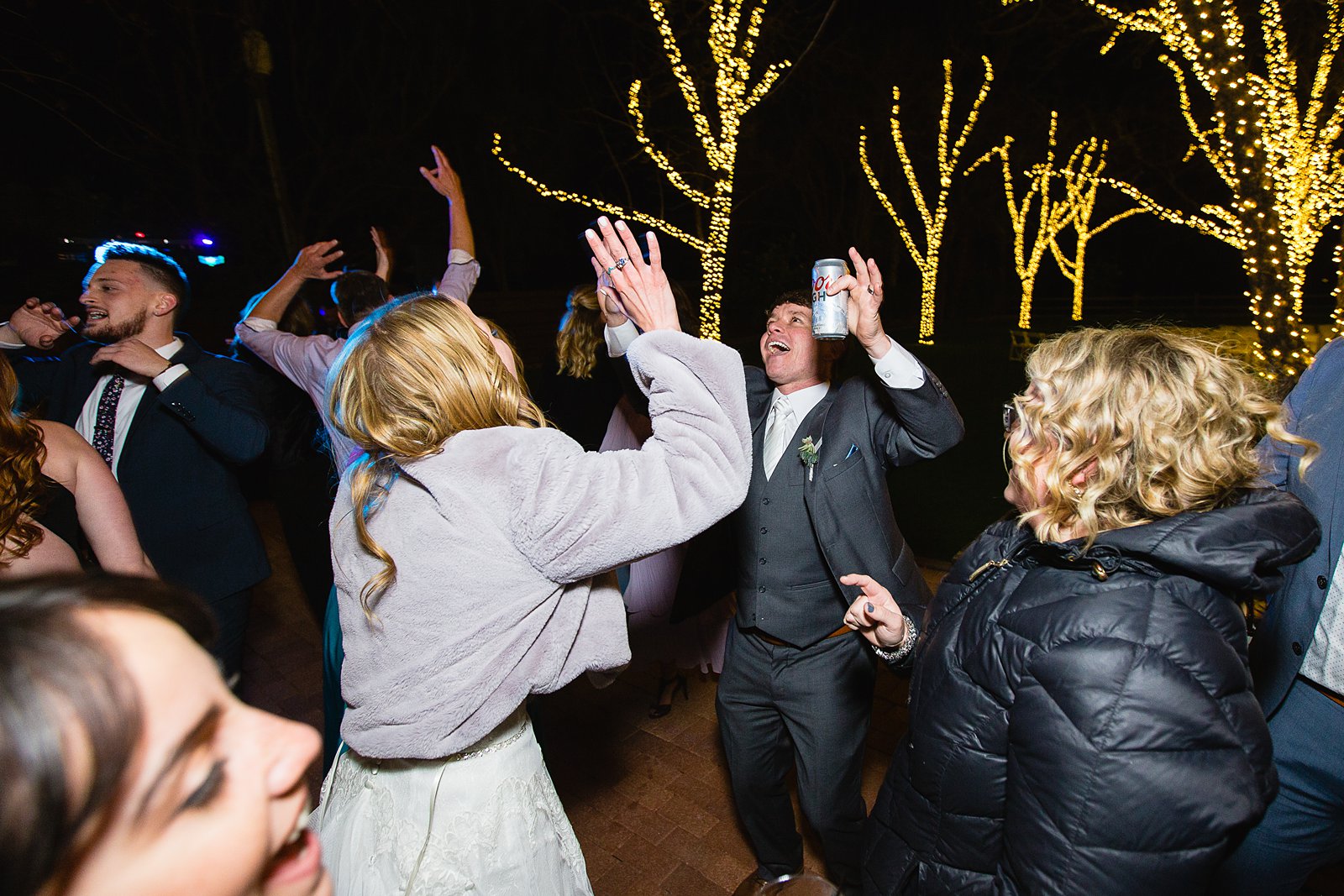 Bride and groom dancing with guests at Venue At The Grove wedding reception by Phoenix wedding photographer PMA Photography