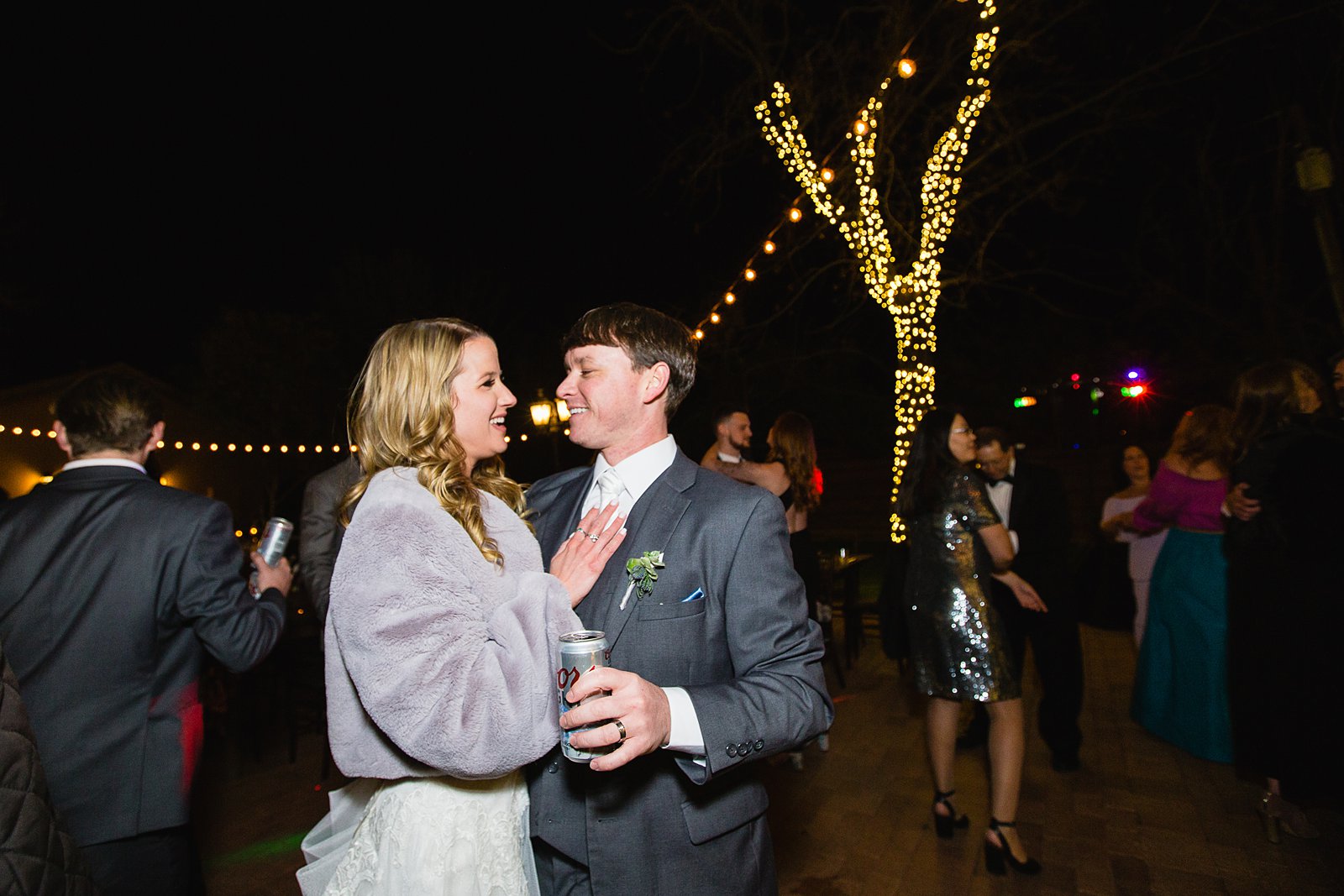 Bride and groom dancing with guests at Venue At The Grove wedding reception by Phoenix wedding photographer PMA Photography