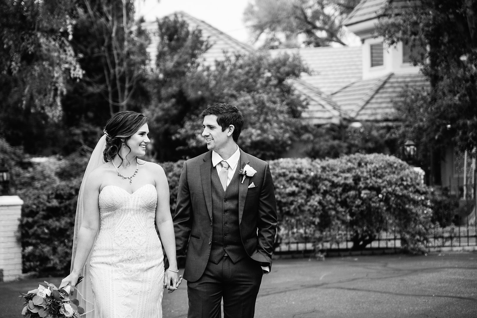 Bride and Groom walking together during their The Wright House wedding by Arizona wedding photographer PMA Photography.