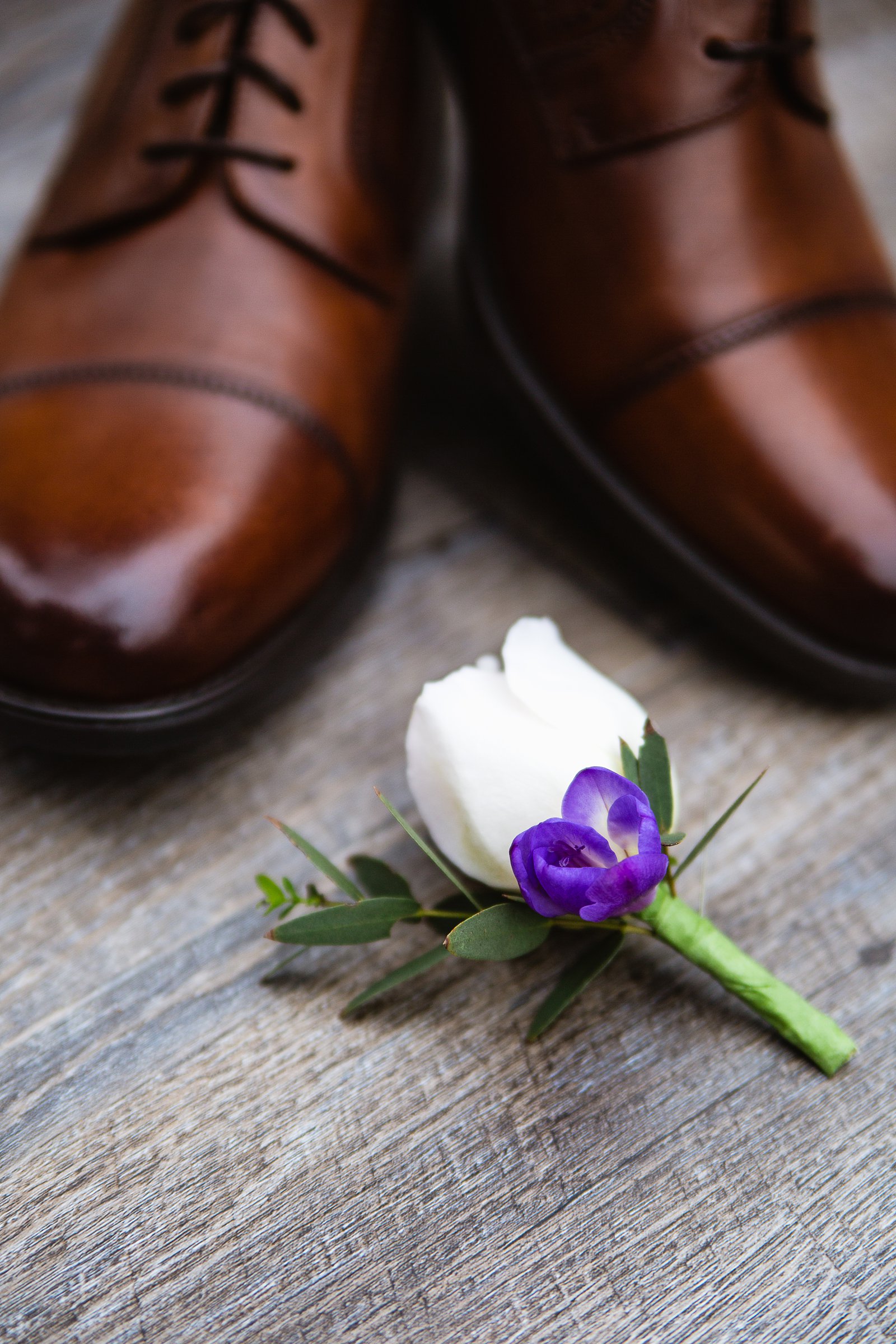 Grooms simple garden inspired white and purple boutonniere by PMA Photography.