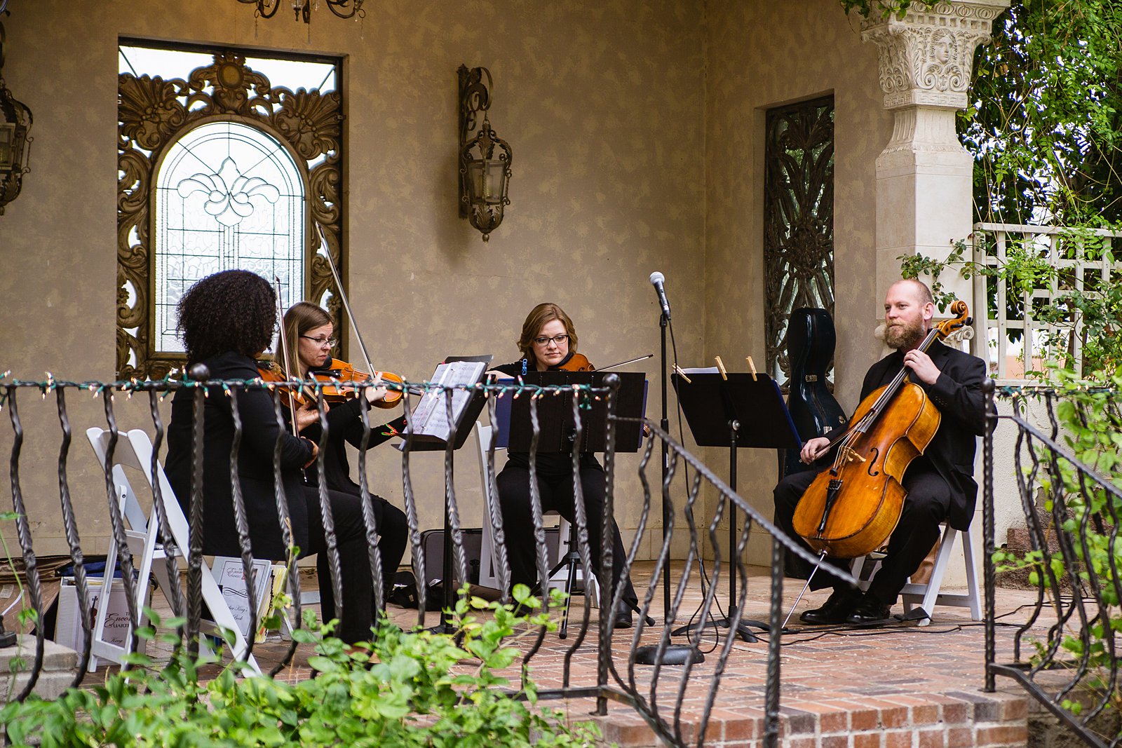 Quartet playing to greet guests to this garden wedding ceremony by PMA Photography.