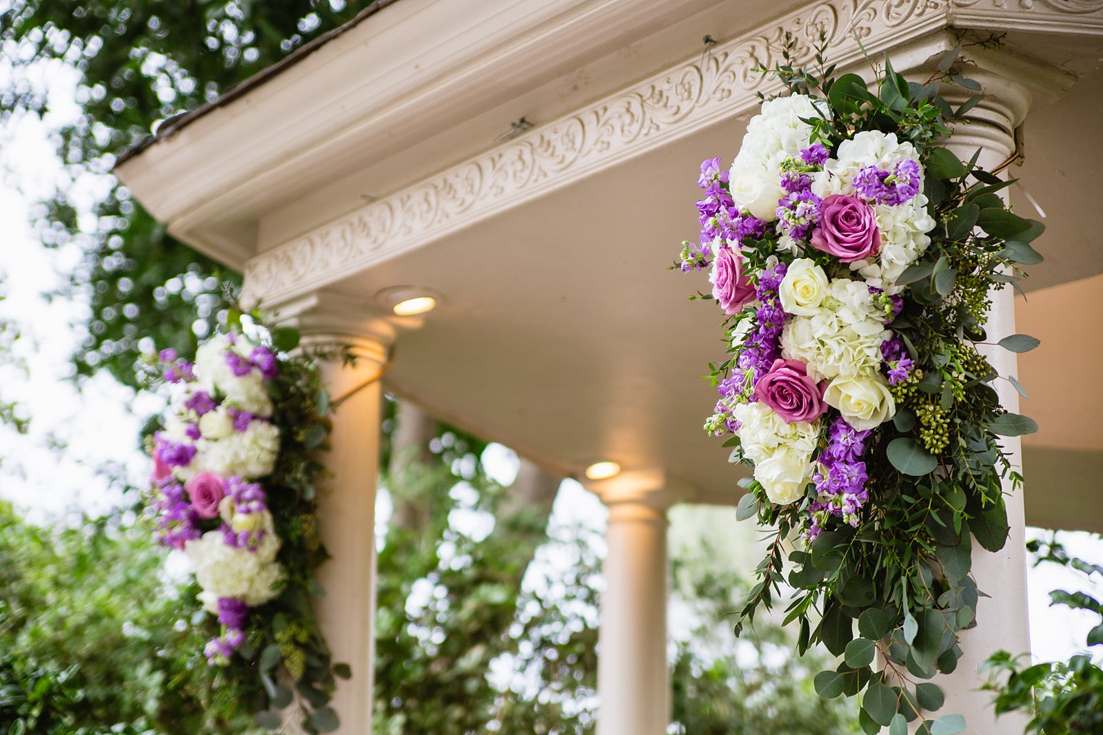 White and purple ceremony arch decor on a garden gazebo at The Wright House wedding by Arizona wedding photographer PMA Photography.