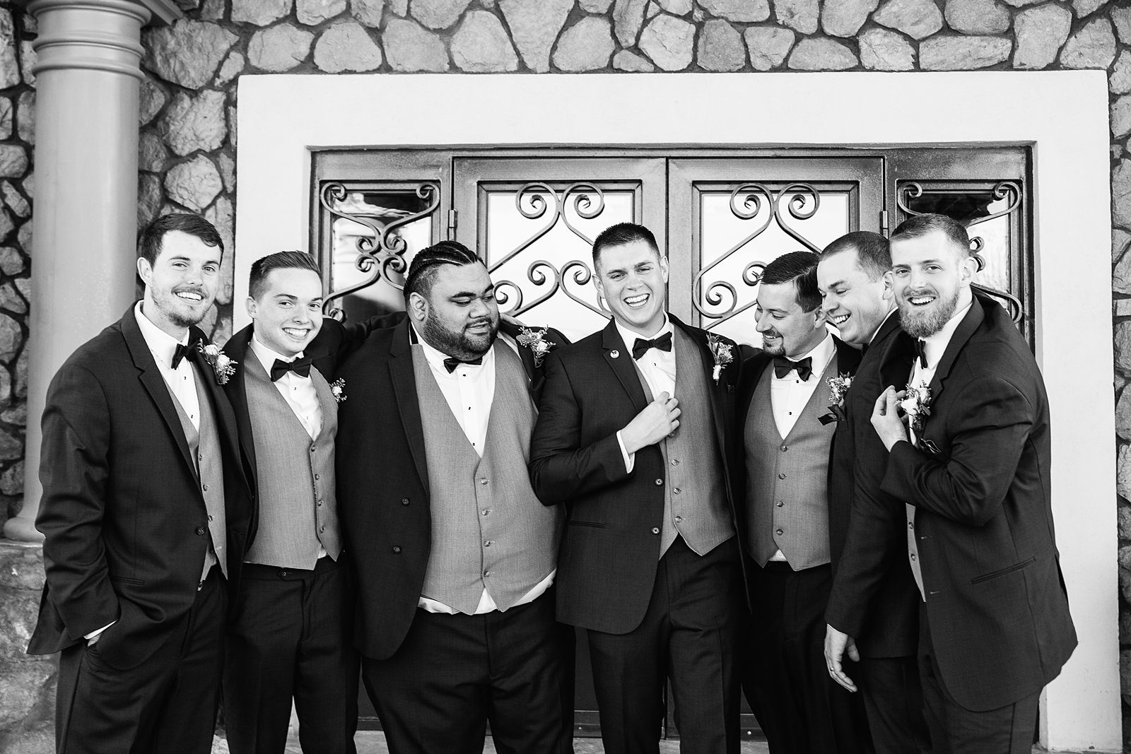 Groom and groomsmen laughing together at Superstition Manor wedding by Mesa wedding photographer PMA Photography.