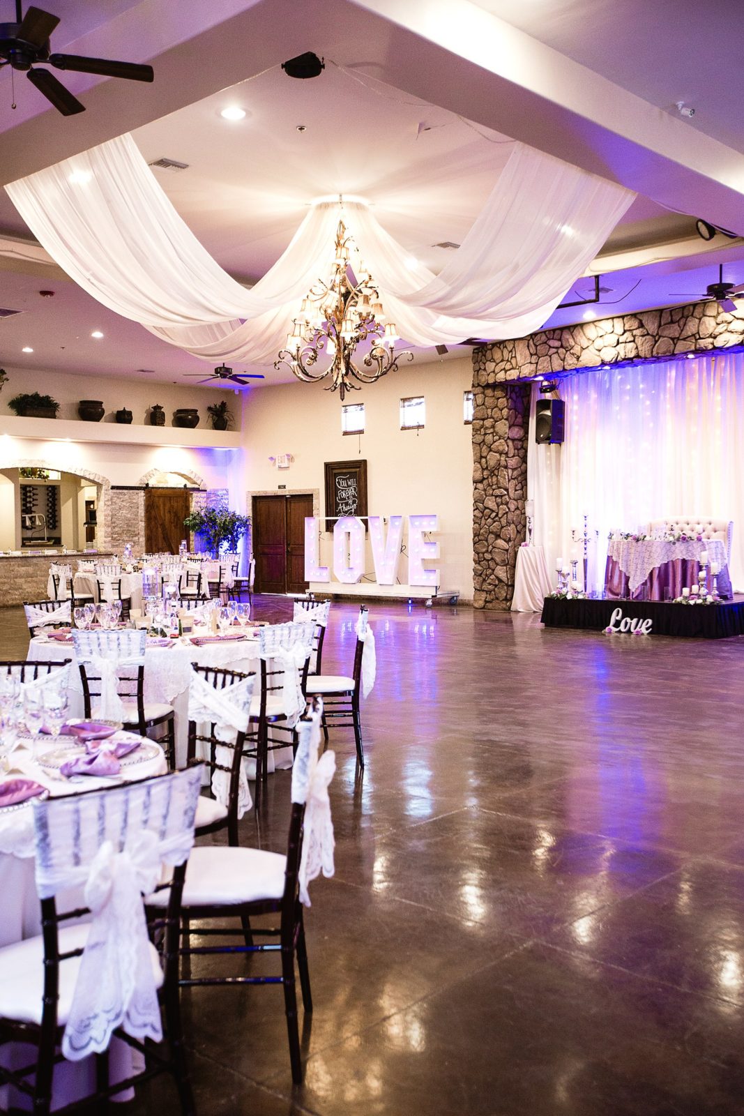 Rustic and romantic purple and white reception decorations at a Superstition Manor wedding reception by PMA Photography.