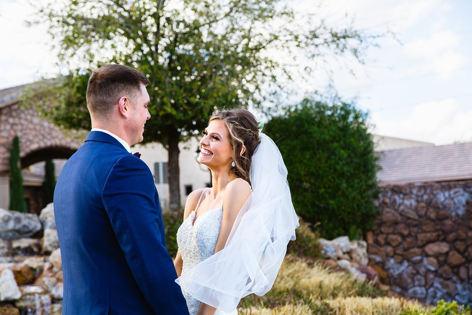 Bride and Groom laughing together during their Superstition Manor wedding by Arizona wedding photographer PMA Photography.