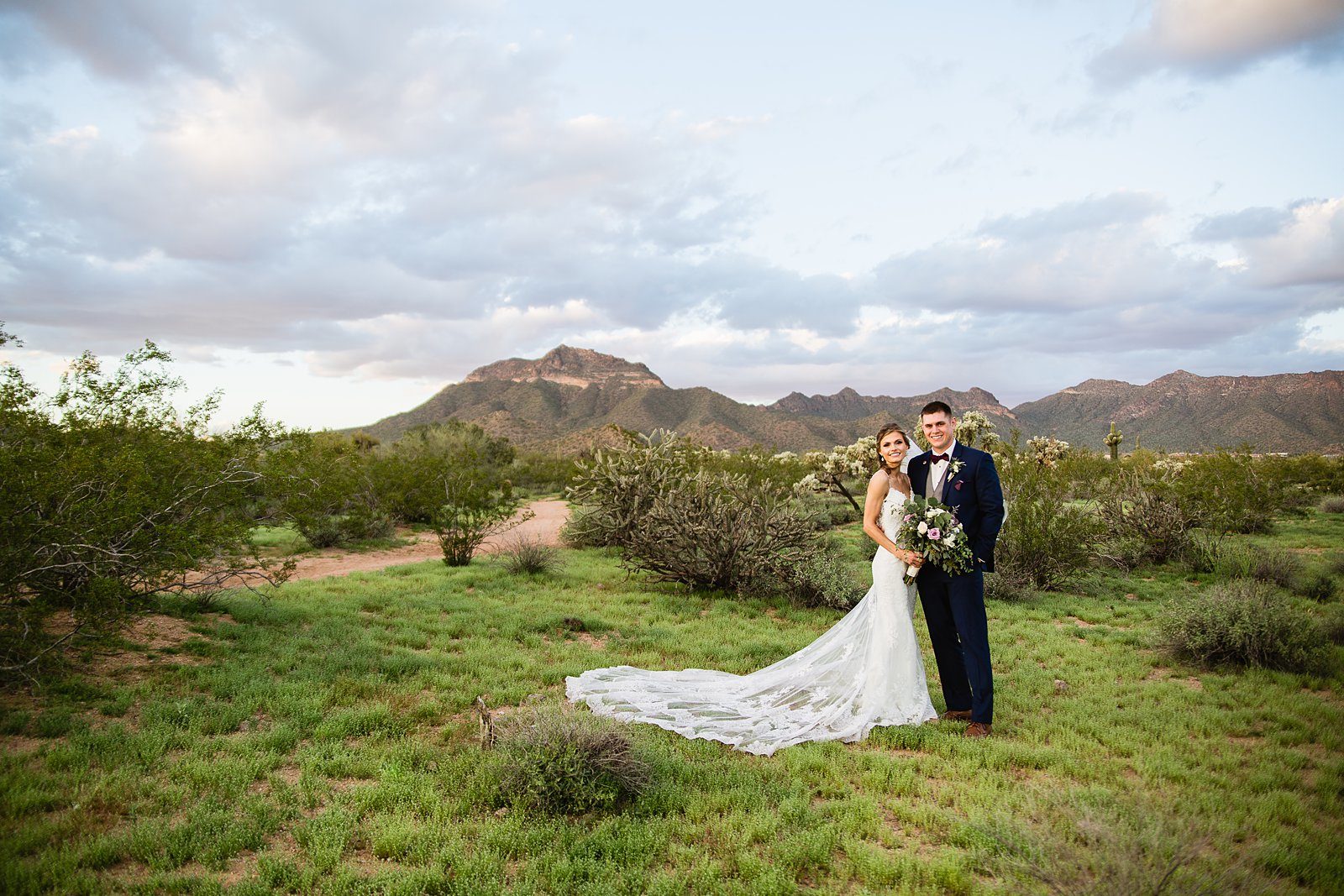 Bride and groom in the desert at their Superstition Manor Wedding by Mesa wedding photographer PMA Photography.