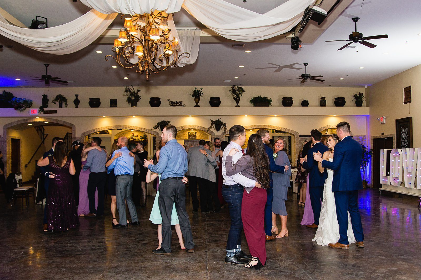 Bride and Groom dancing with guests at their Superstition Manor wedding reception by Arizona wedding photographer PMA Photography