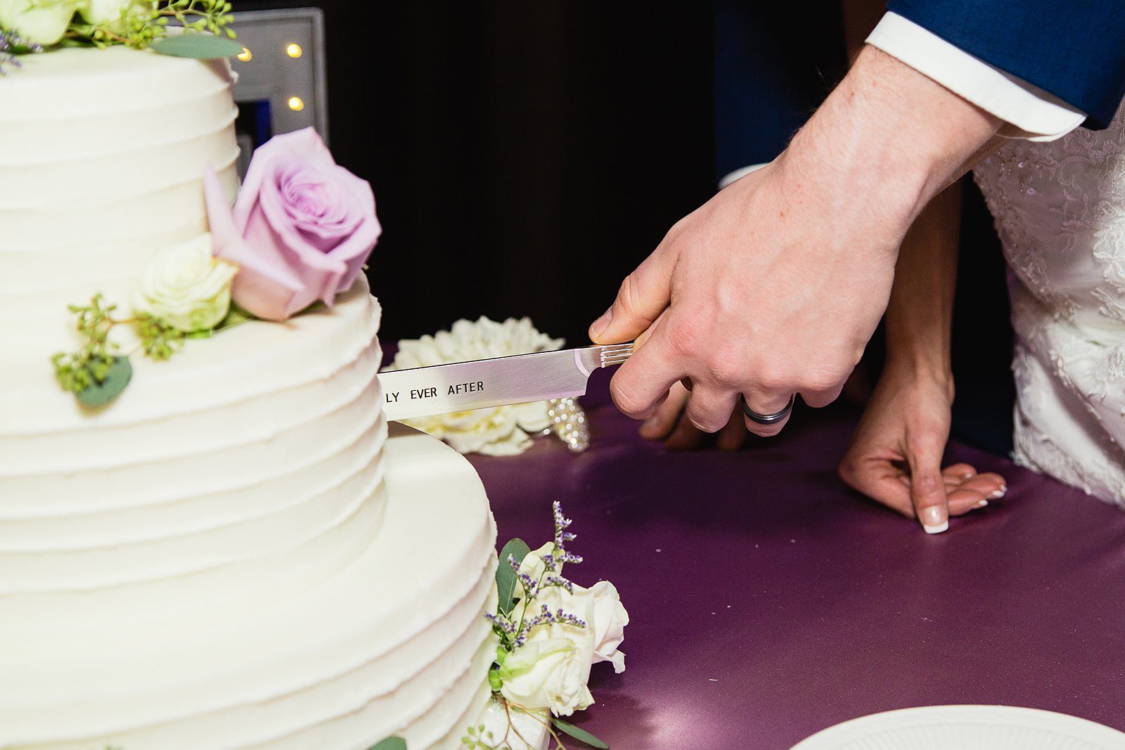 Bride and Groom cutting their wedding cake at their Superstition Manor wedding reception by Arizona wedding photographer PMA Photography.