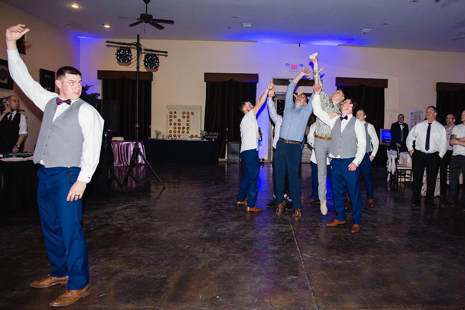 Garter toss at Superstition Manor wedding reception by Mesa wedding photographer PMA Photography.