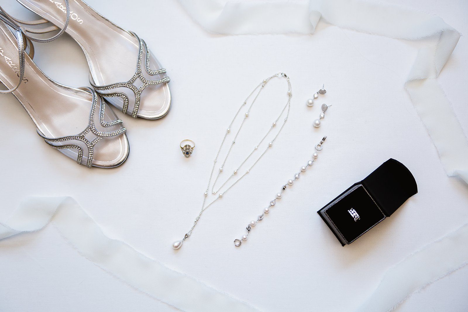 Bride's wedding day details of her diy jewelry, silver wedding shoes, antique ring, and stacking wedding bands by PMA Photography.