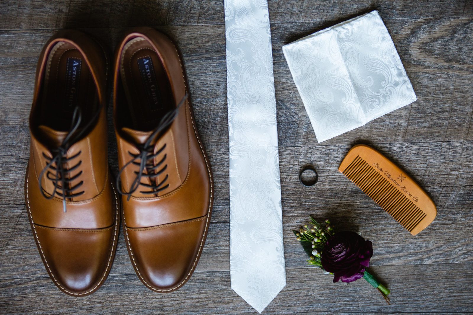 Groom's tan and white wedding day details including his beard comb by PMA Photography.