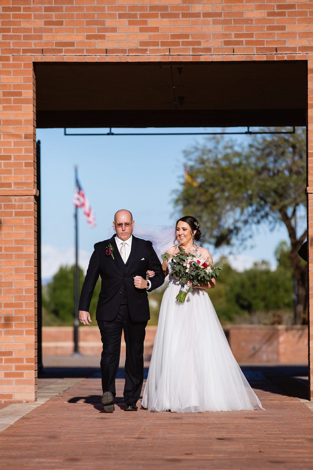 Bride walking down aisle during Arizona Heritage Center at Papago Park wedding ceremony by Arizona wedding photographer PMA Photography.