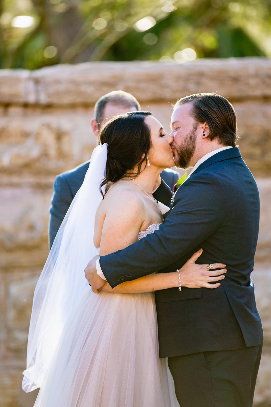 Bride and Groom share their first kiss during their wedding ceremony at Arizona Heritage Center at Papago Park by Arizona wedding photographer PMA Photography.