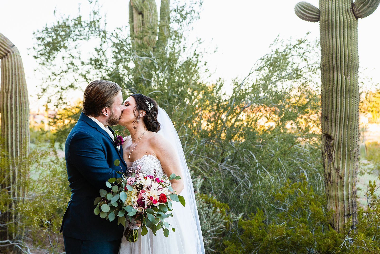Bride and Groom share a kiss during their Arizona Heritage Center at Papago Park wedding by Tempe wedding photographer PMA Photography.
