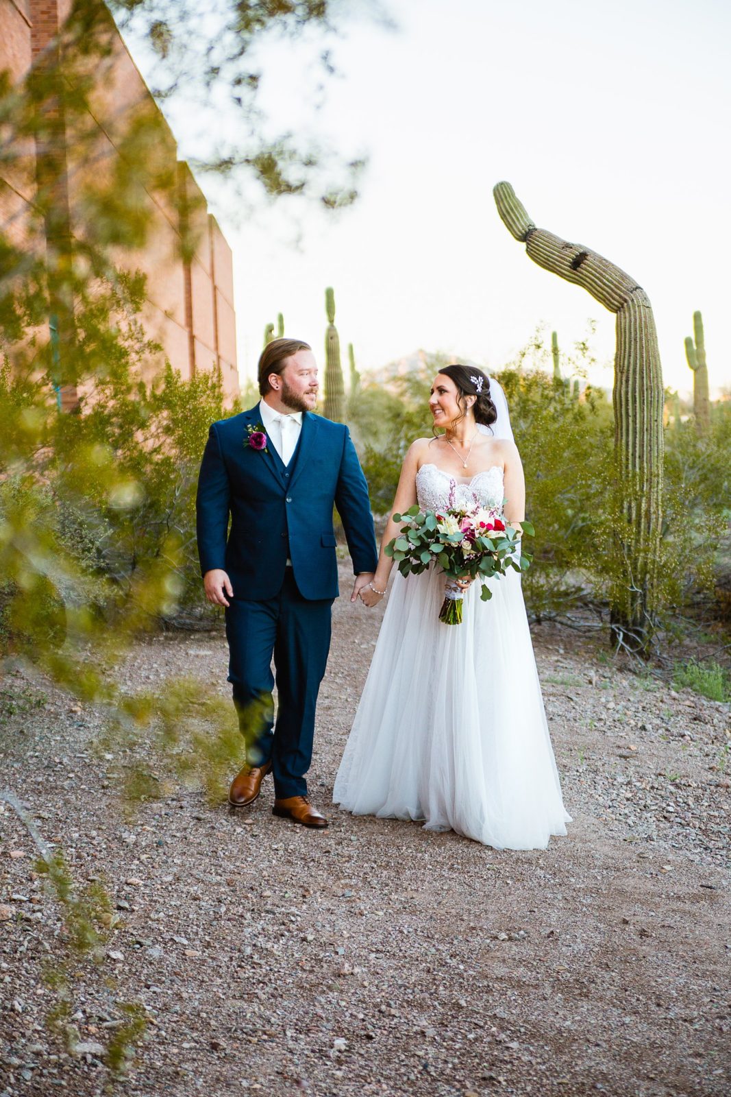 Bride and Groom walking together during their Arizona Heritage Center at Papago Park wedding by Tempe wedding photographer PMA Photography.