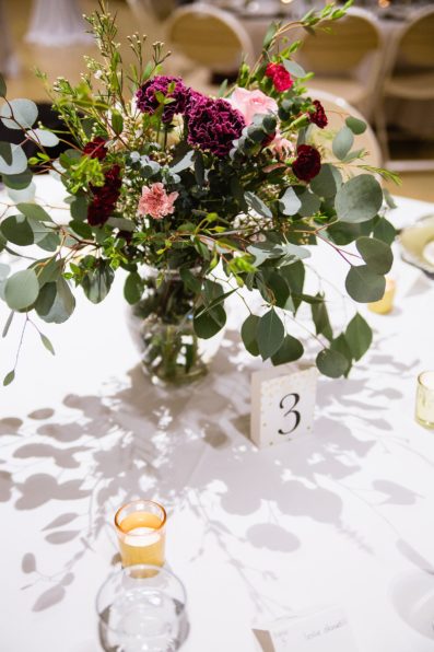 Green, pink, and white floral centerpieces at a wedding reception at Arizona Heritage Center at Papago Park by Arizona wedding photographer PMA Photography.