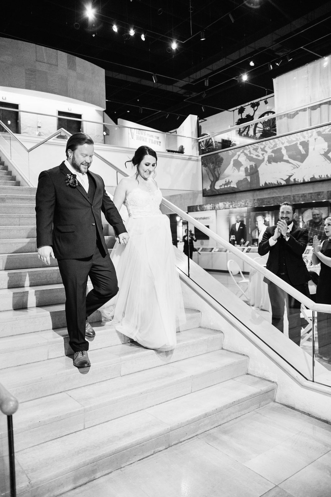 Bride and groom making their grand entrance into their wedding reception by PMA Photography.
