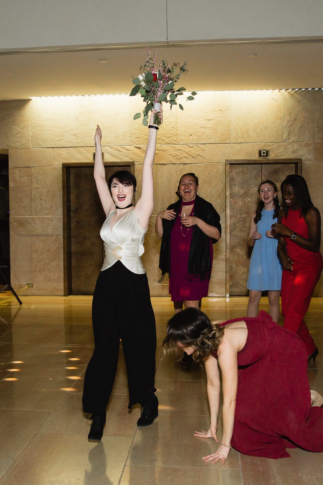 Bouquet toss at Arizona Heritage Center at Papago Park wedding reception by Tempe wedding photographer PMA Photography.