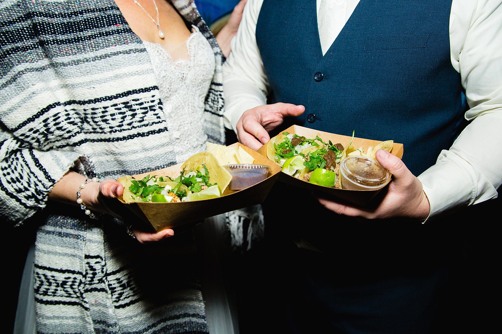 Bride and groom with their late night taco truck at their wedding reception by Arizona wedding photographer PMA Photography.